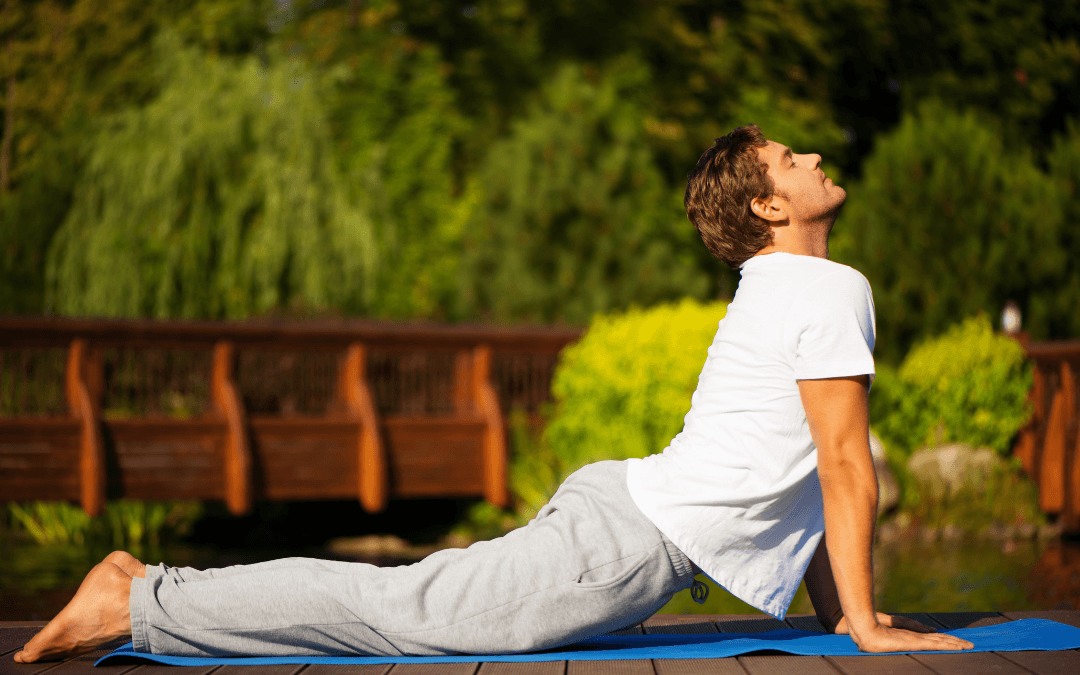 man doing yoga outdoors
